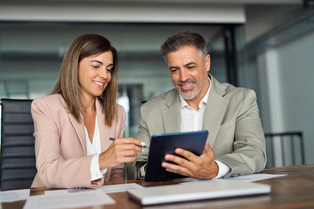 Two Professional Executives Business People Talking Working On Tablet In Office.